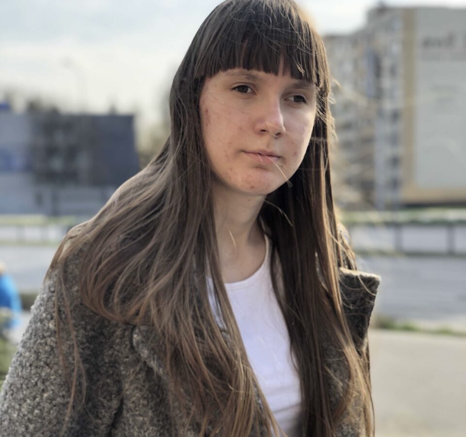 Эльвира Бахарева стоит на фоне многоквартирных домов